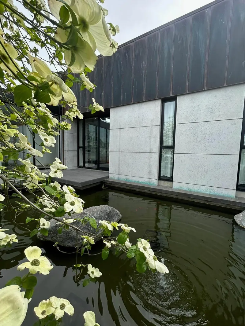 Rectangular formal pond with straight stone edges